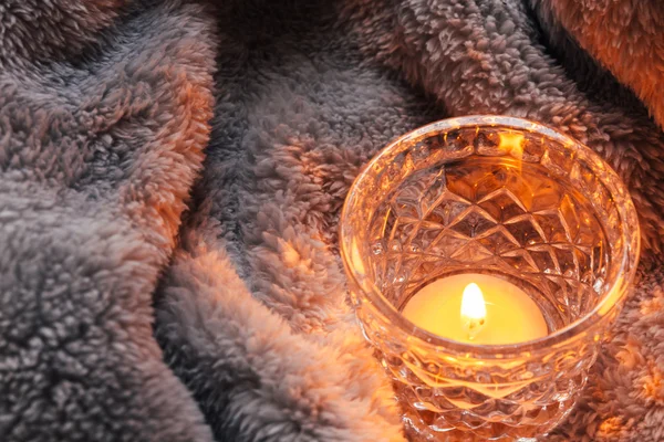 Cosy and soft winter background,candles on a blanket
