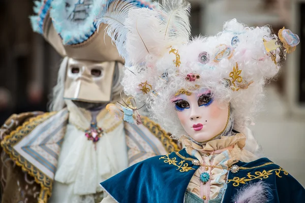 Venice - February 6, 2016: Colourful carnival mask through the streets of  Venice