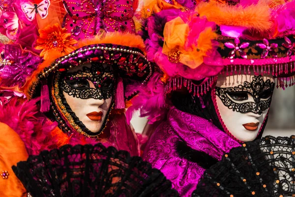 Venice - February 6, 2016: Colourful Carnival mask through the streets of  Venice