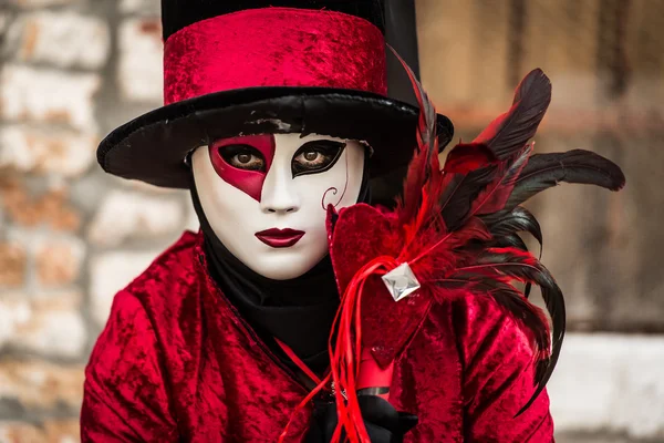 Venice - February 6, 2016: Colourful Carnival mask through the streets of  Venice