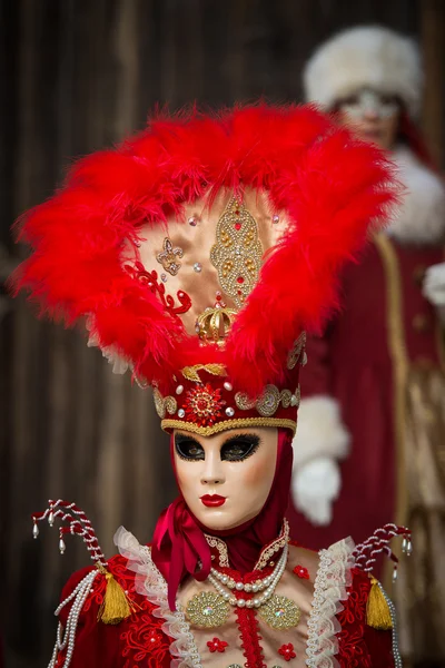 Venice - February 6, 2016: Colourful Carnival mask through the streets of  Venice