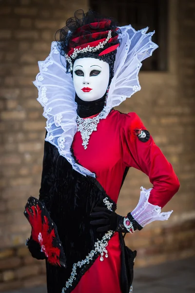 Venice - February 6, 2016: Colourful Carnival mask through the streets of  Venice