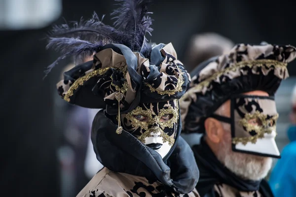 Venice - February 6, 2016: Colourful Carnival mask through the streets of  Venice