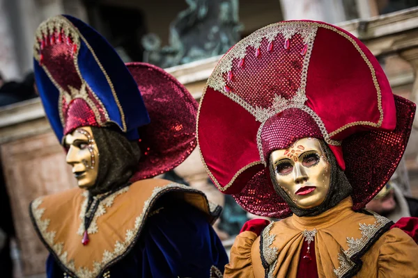Venice - February 6, 2016: Colourful Carnival mask through the streets of  Venice