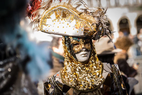 Venice - February 6, 2016: Colourful Carnival mask through the streets of  Venice