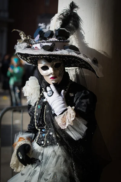 Venice - February 6, 2016: Colourful Carnival mask through the streets of  Venice