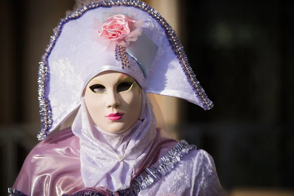 Venice - February 6, 2016: Colourful Carnival mask through the streets of  Venice