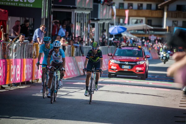 Corvara, Italy May 21, 2016; Professional cyclists  pass the finish line in Corvara