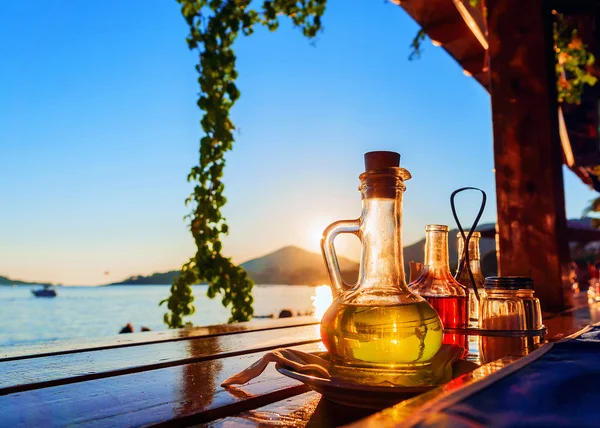 Bottle with olive oil on a background of sea sunset
