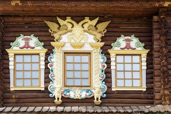 Facade of the old Russian chopped house with carved wooden archi