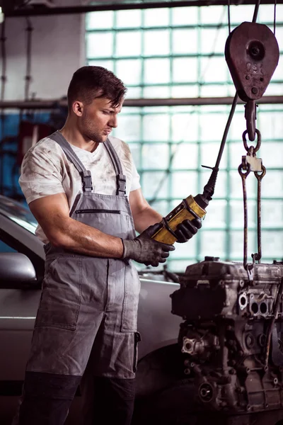 Automotive technician repairing engine