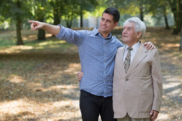 Young man showing something grandfather