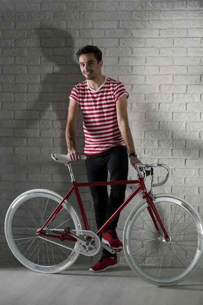 Happy hipster boy and his bike