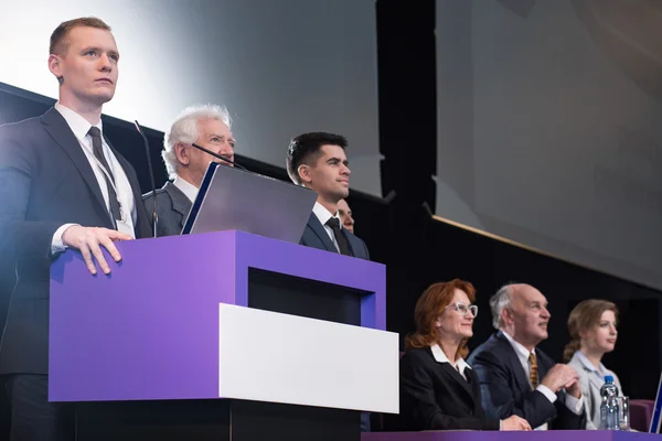 Businessman standing at podium