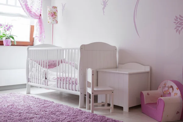 White and rose baby room
