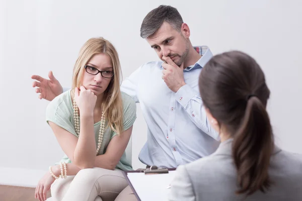 Young married unhappy couple on psychotherapy session