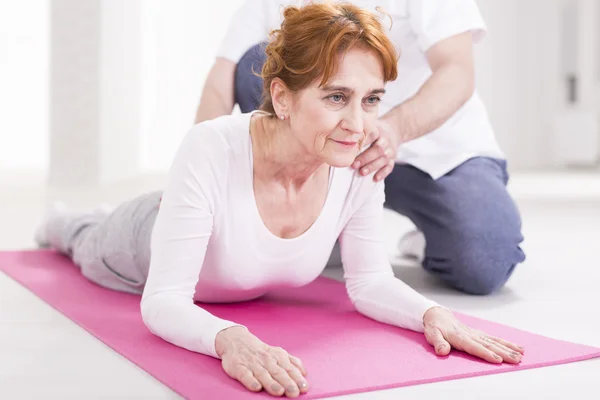 Elderly woman and spine stretching