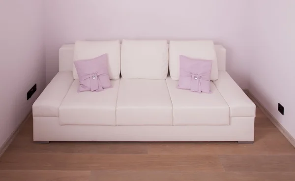 White leather sofa with cushions