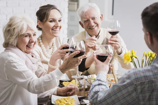 Family toasting wine glasses