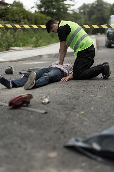Policeman resuscitating injured man