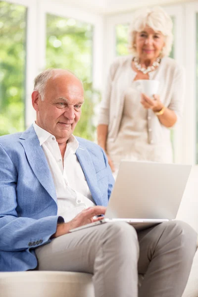 Active seniors with laptop
