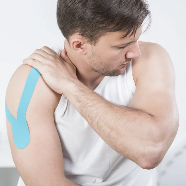 Athletic man during kinesiotherapy