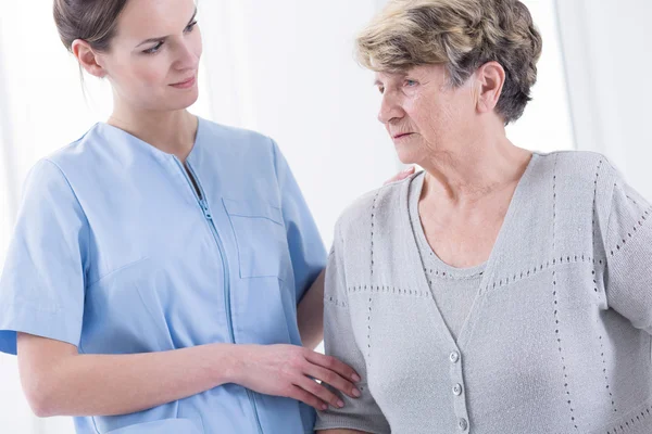 Senior lady with her nurse company