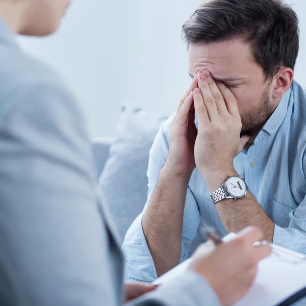 Man crying during psychotherapy