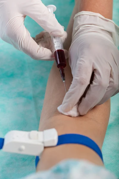 Doctor taking a blood sample