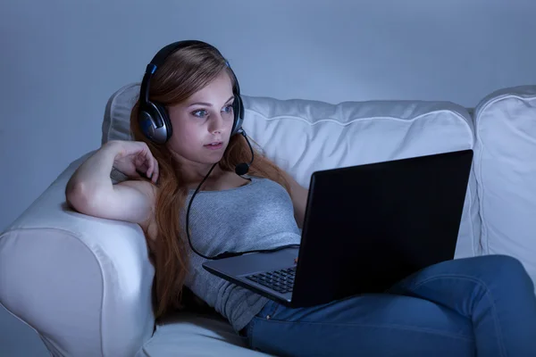 Girl with headphones using computer