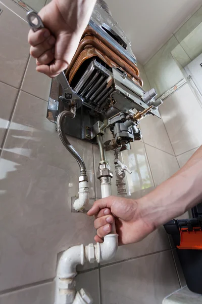 Handyman repairing gas water heater