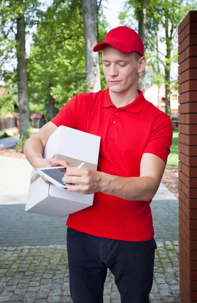 Delivery man with a tablet