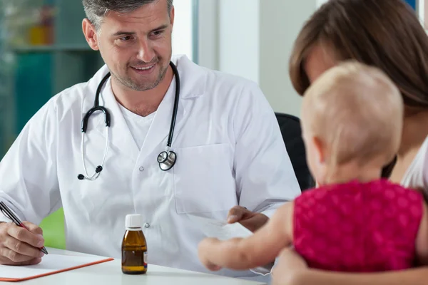Pediatrician giving little girl a recipe