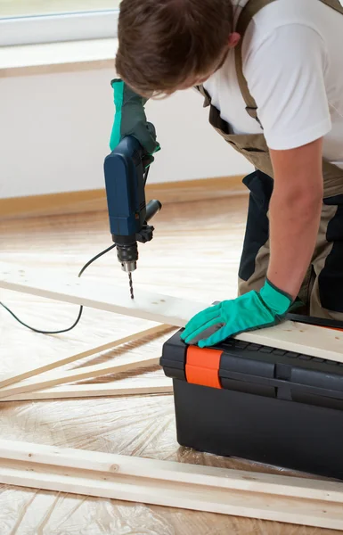 Man using electric drill at home