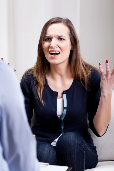 Angry young woman during psychotherapy