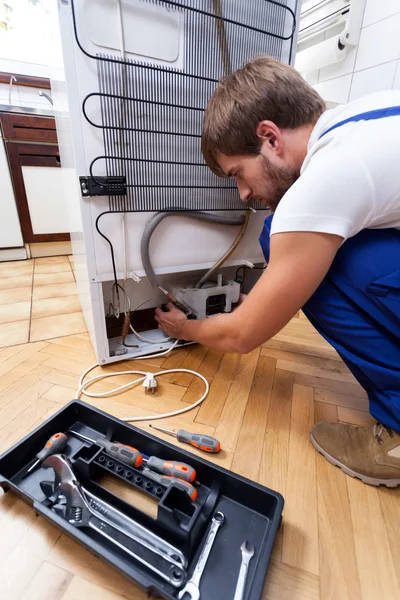 Repairman with tools in the kitchen