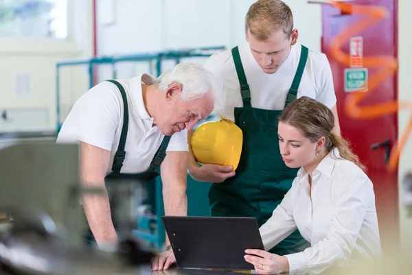 Manager talking with plant workers