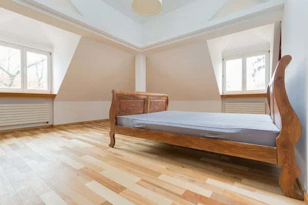 Empty room with old fashioned bed