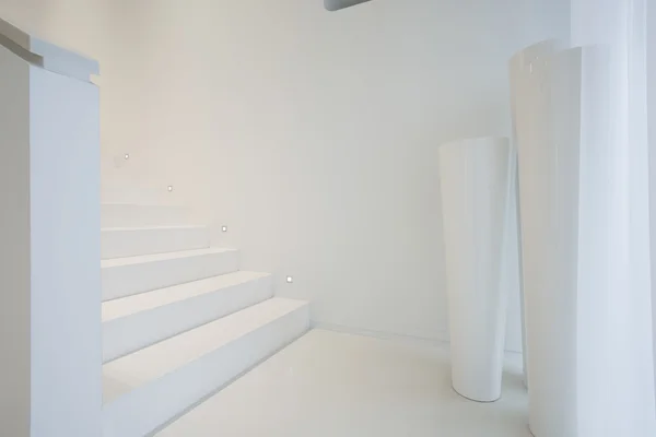 White staircase inside pure house