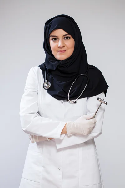 Muslim doctor with reflex hammer