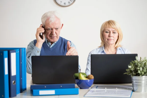 Two elderly colleagues