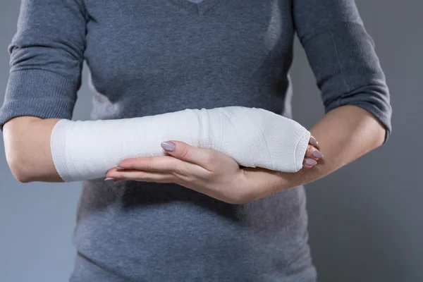 Woman support her hand in bandage