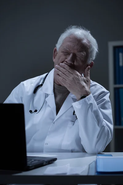 Overworked doctor yawning