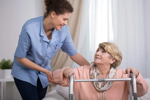 Senior woman using walking frame