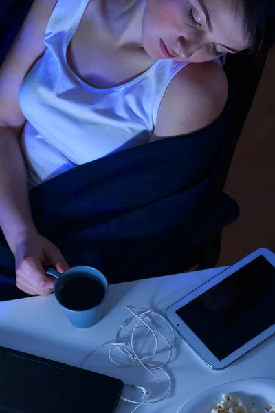 Sleeping woman holding cup