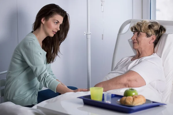 Daughter assisting ill mother