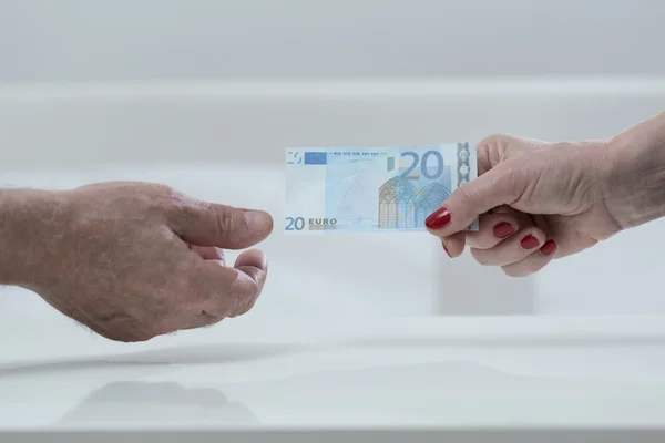 Handing an euro banknote