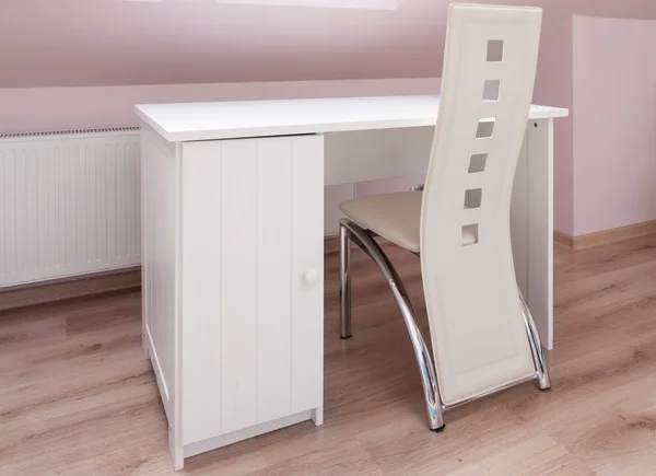 White desk and designed chair