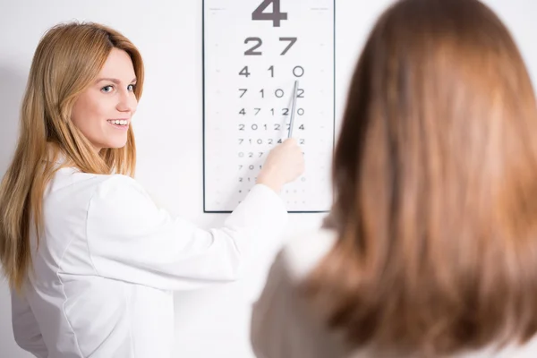 Eye specialist using Snellen test