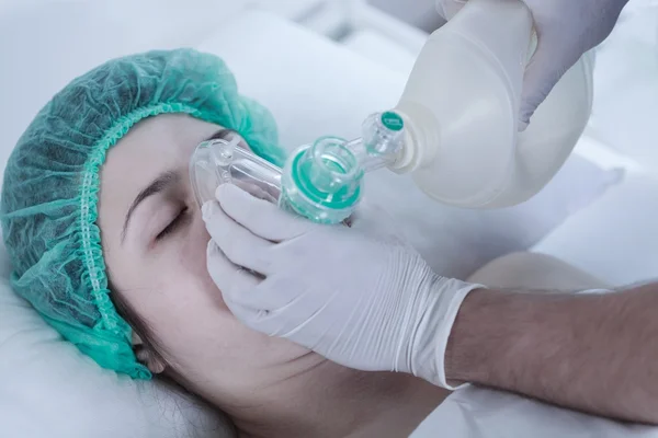 Woman lying in oxygen mask